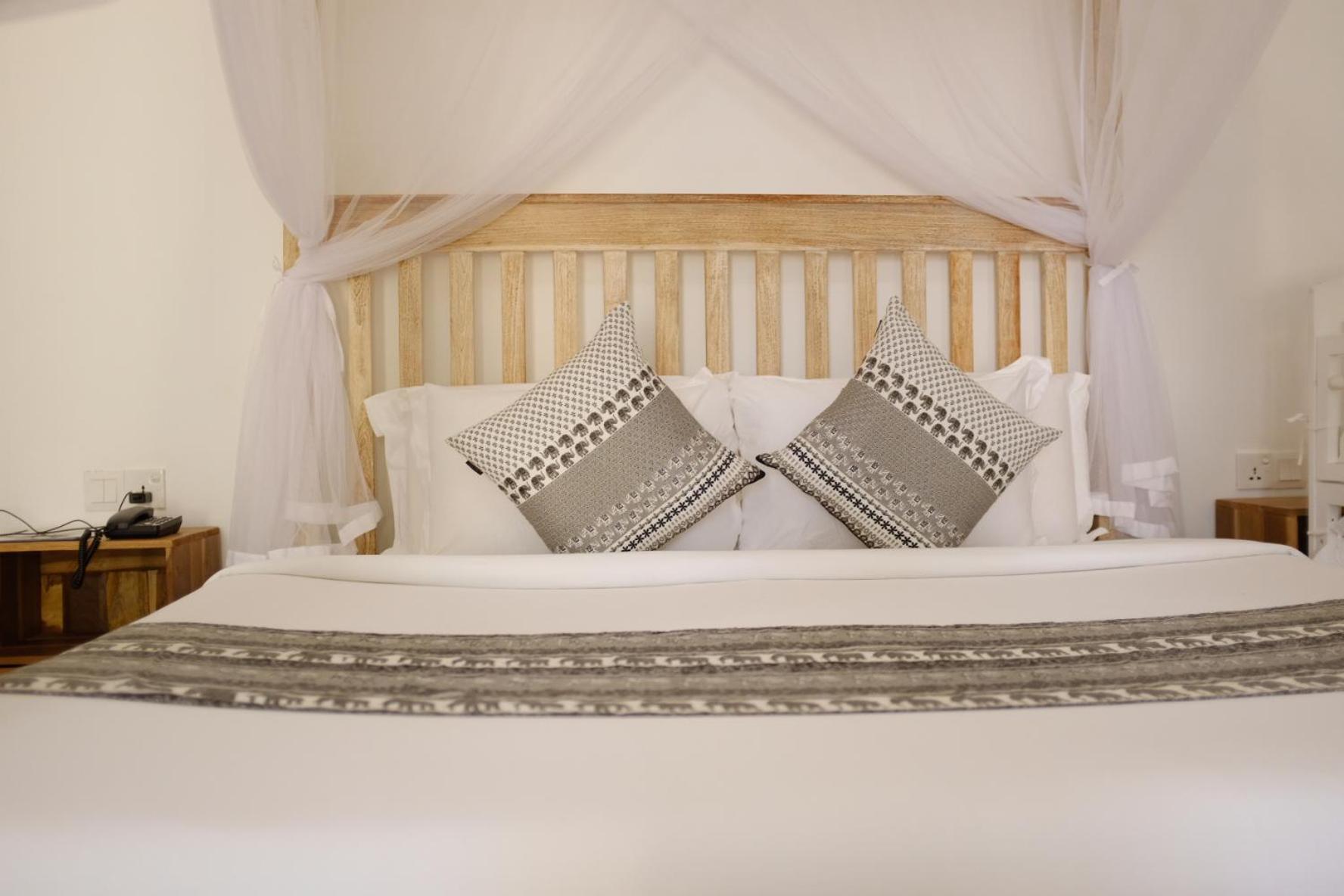 Nivadoo Resort Sigiriya Kamer foto A bed with a mosquito net